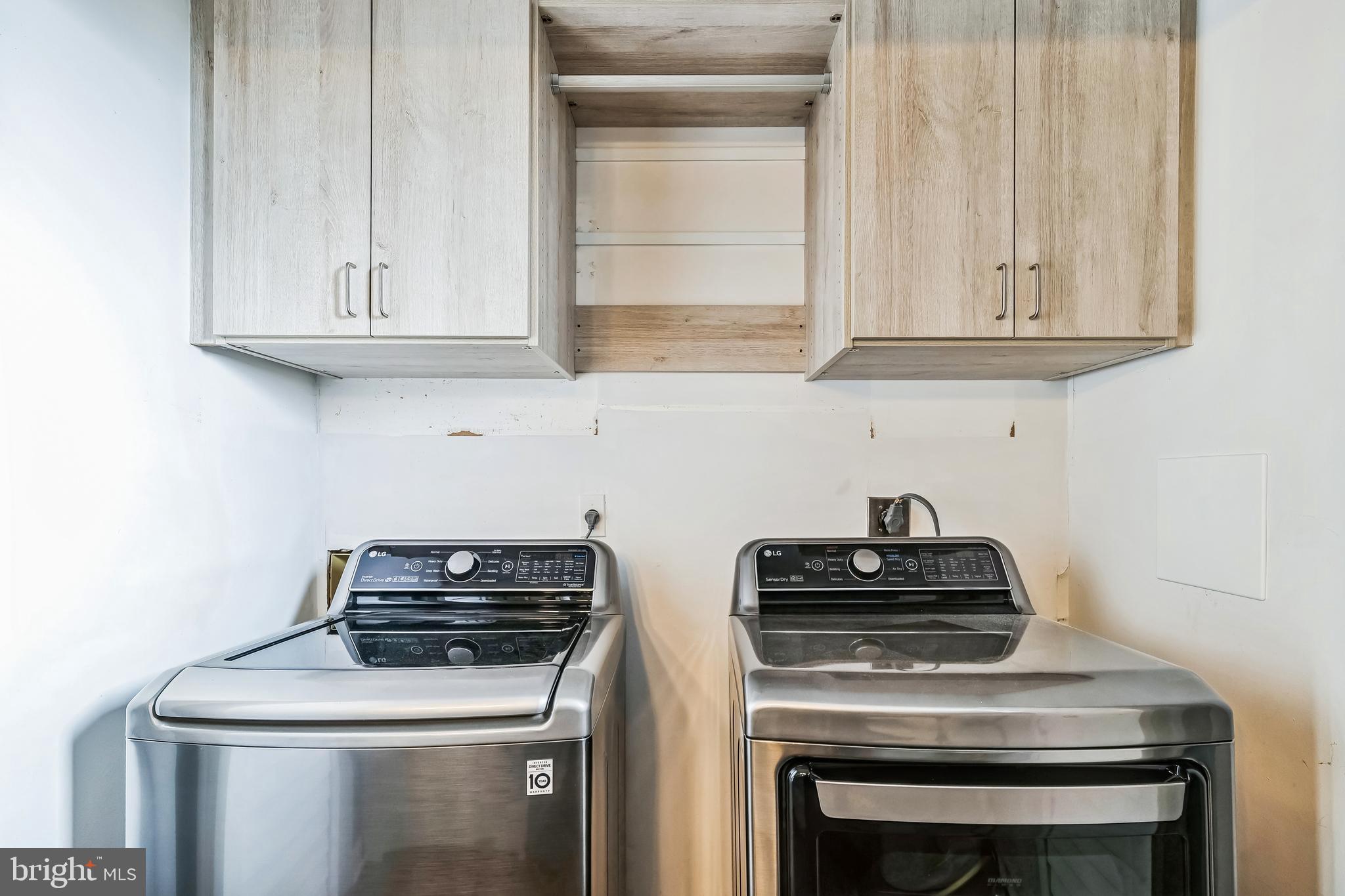 2105 Silver Lane Road Baltimore, MD 21221 - Photo 34 of 55 a kitchen with white cabinets and black appliances
