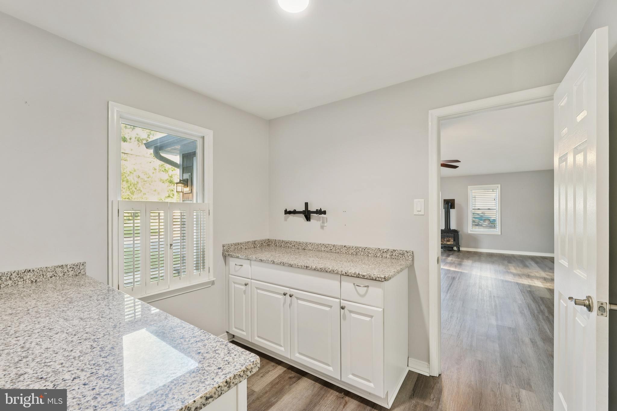 2105 Silver Lane Road Baltimore, MD 21221 - Photo 35 of 55 a hallway with sink and mirror
