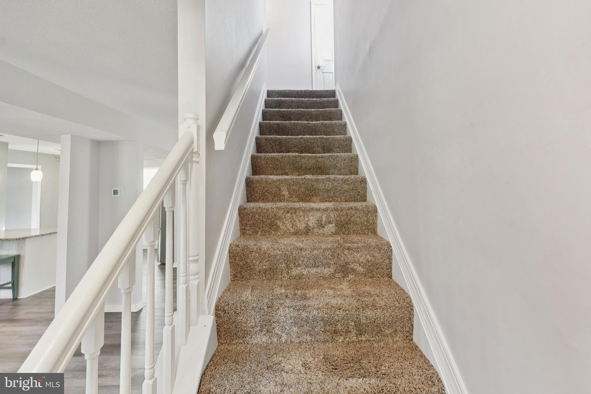 2105 Silver Lane Road Baltimore, MD 21221 - Photo 36 of 55 a view of staircase with wooden floor and white walls