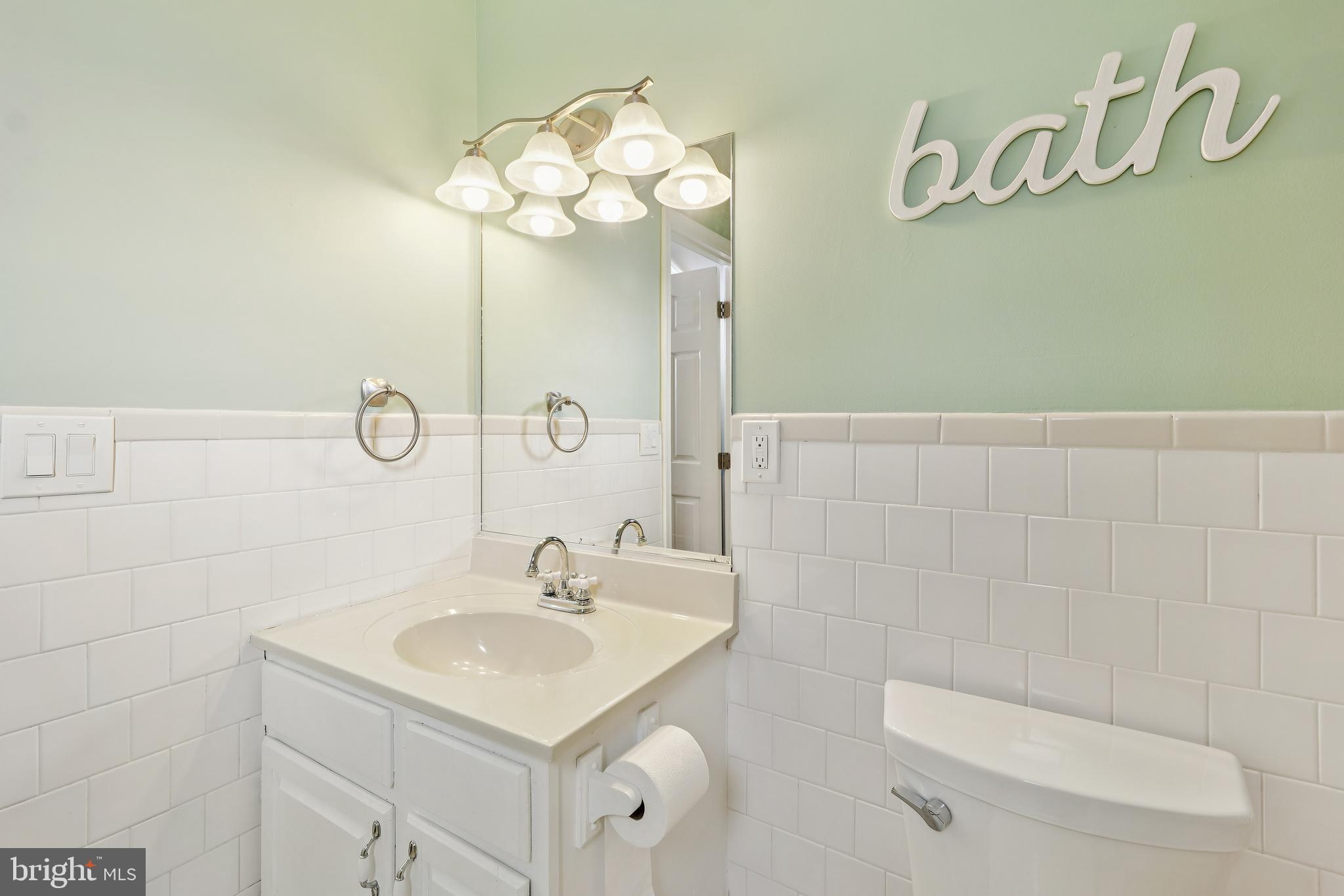 2105 Silver Lane Road Baltimore, MD 21221 - Photo 37 of 55 a bathroom with a sink a light fixture and a toilet