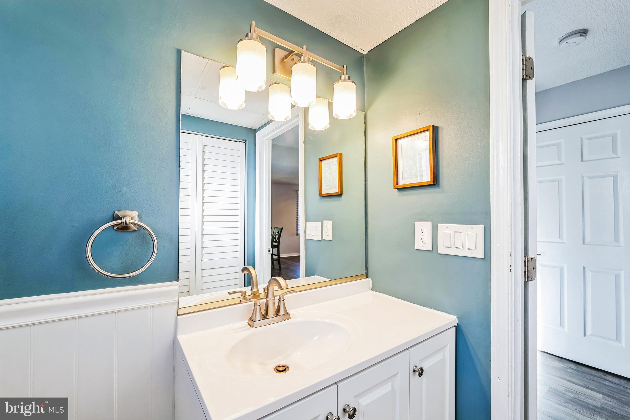 2105 Silver Lane Road Baltimore, MD 21221 - Photo 38 of 55 a bathroom with a sink and a mirror