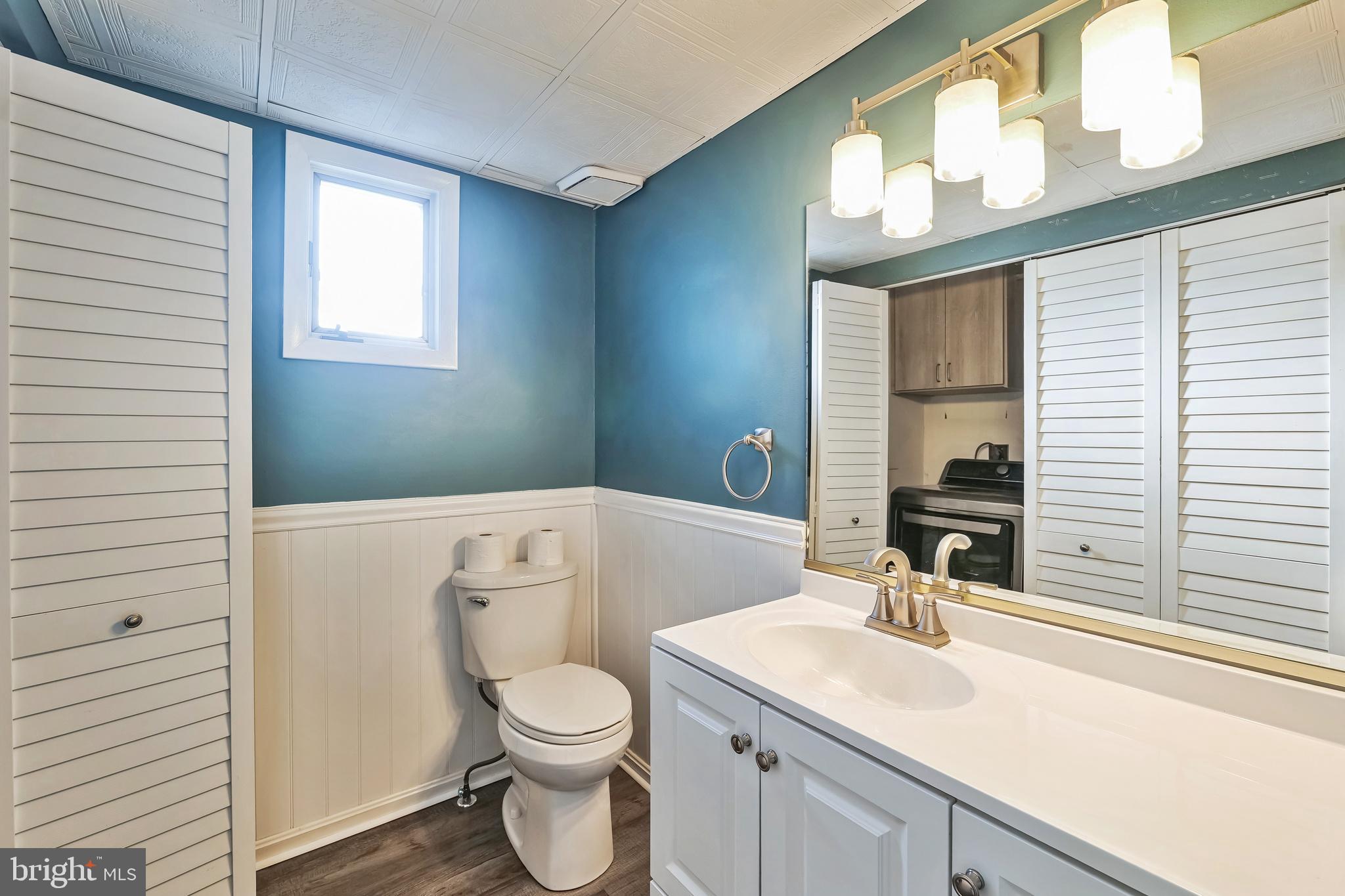 2105 Silver Lane Road Baltimore, MD 21221 - Photo 39 of 55 a bathroom with a toilet sink and mirror
