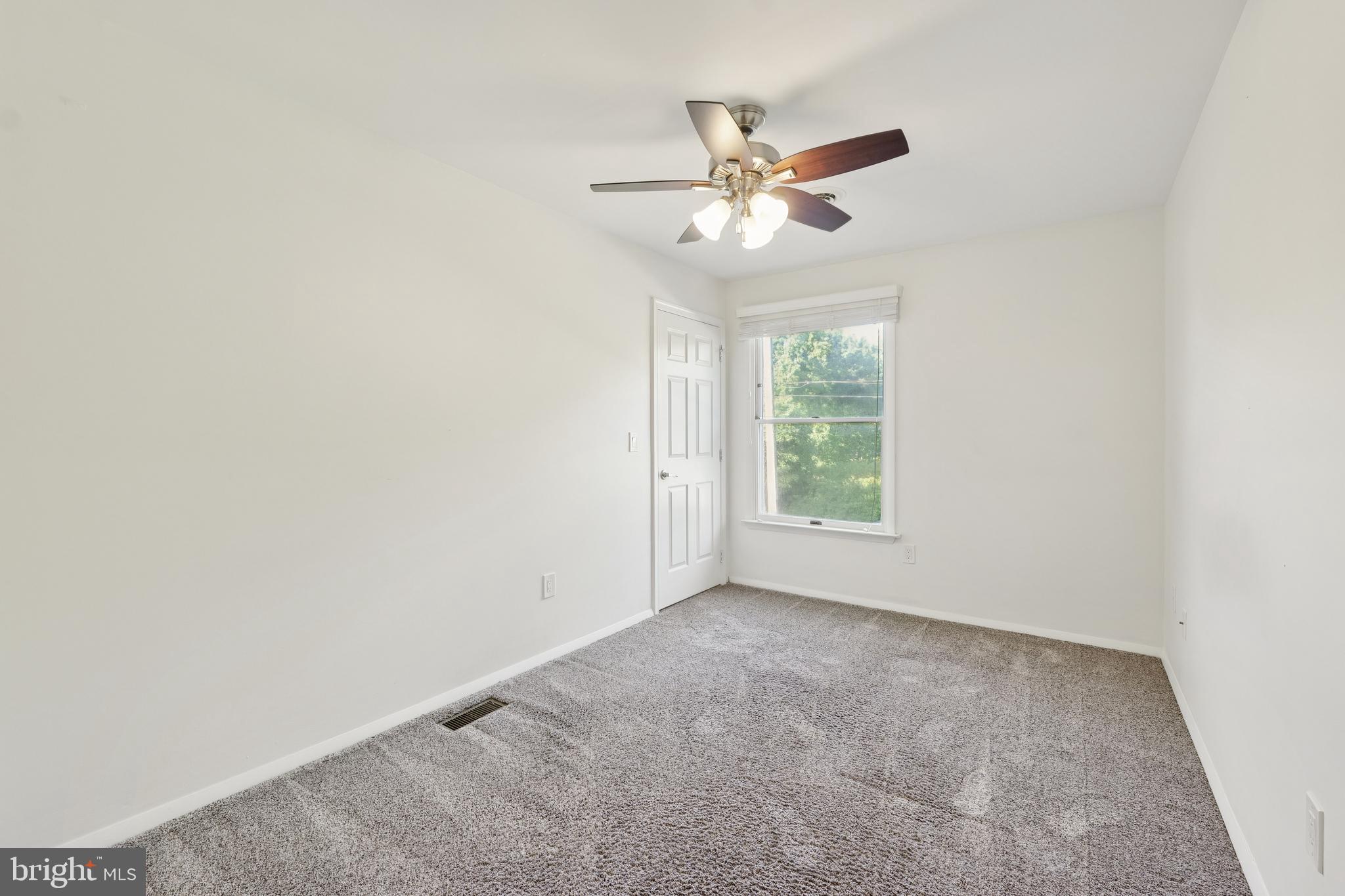 2105 Silver Lane Road Baltimore, MD 21221 - Photo 44 of 55 an empty room with windows and fan
