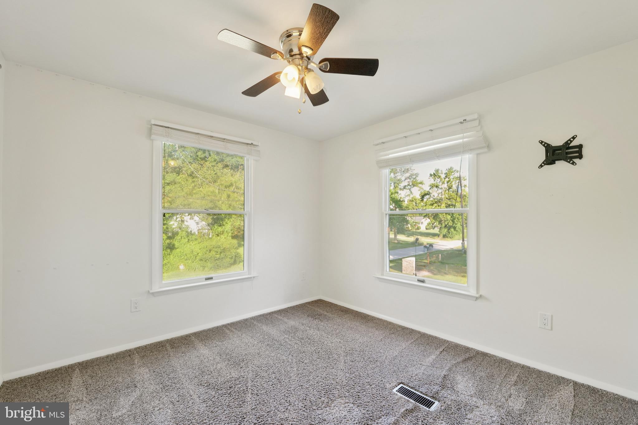 2105 Silver Lane Road Baltimore, MD 21221 - Photo 47 of 55 an empty room with windows and a ceiling fan
