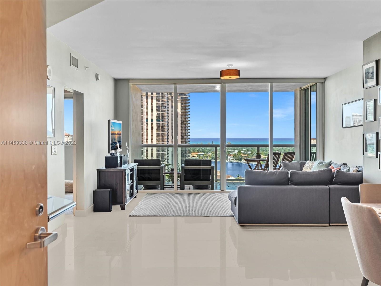 19400 Turnberry Way, Unit 1221 Aventura, FL 33180 - Photo 1 of 27 a living room with furniture a fireplace and a window