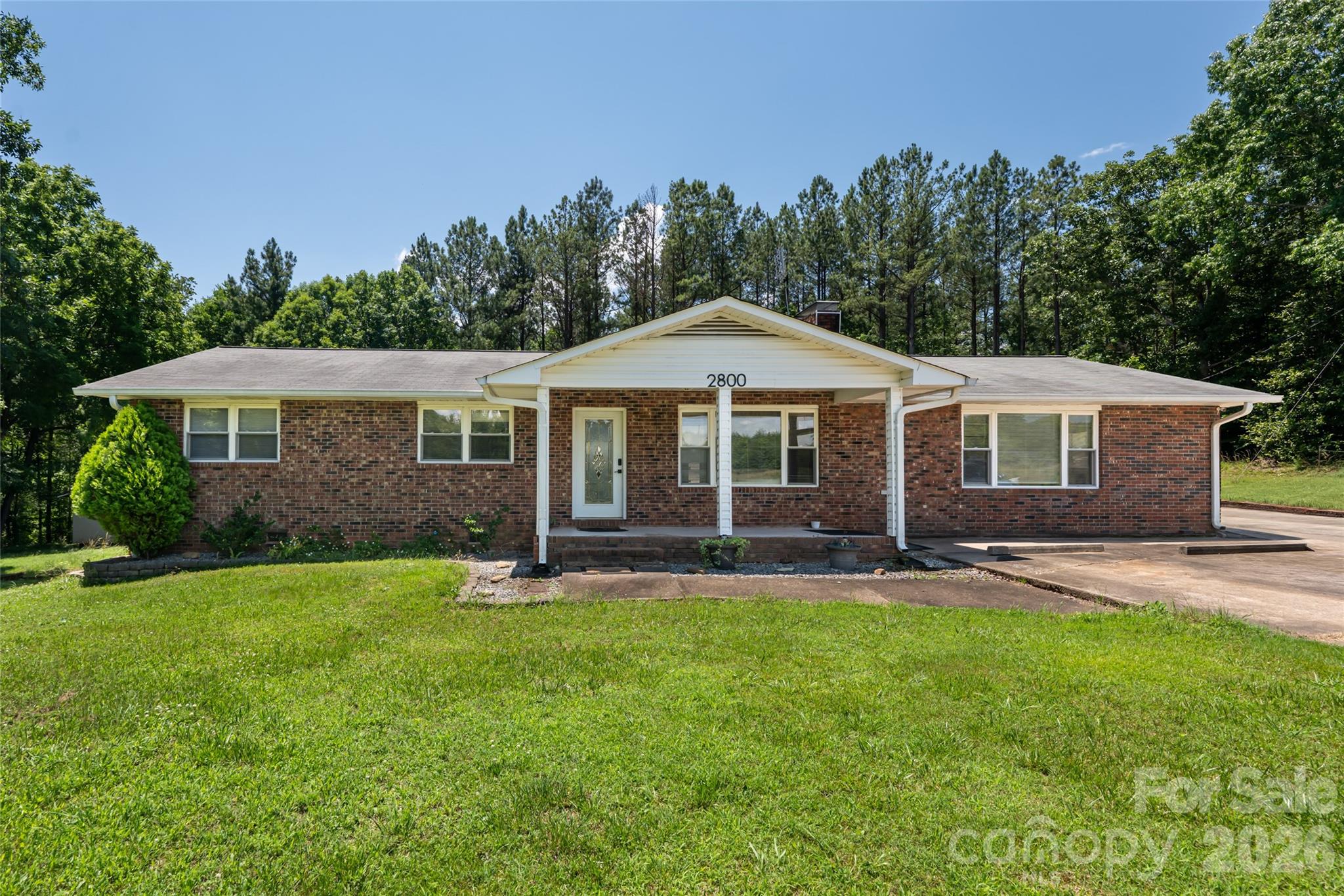 2800 Coxe Road Tryon, NC 28782 - Photo 4 of 40 a front view of a house with a yard and trees