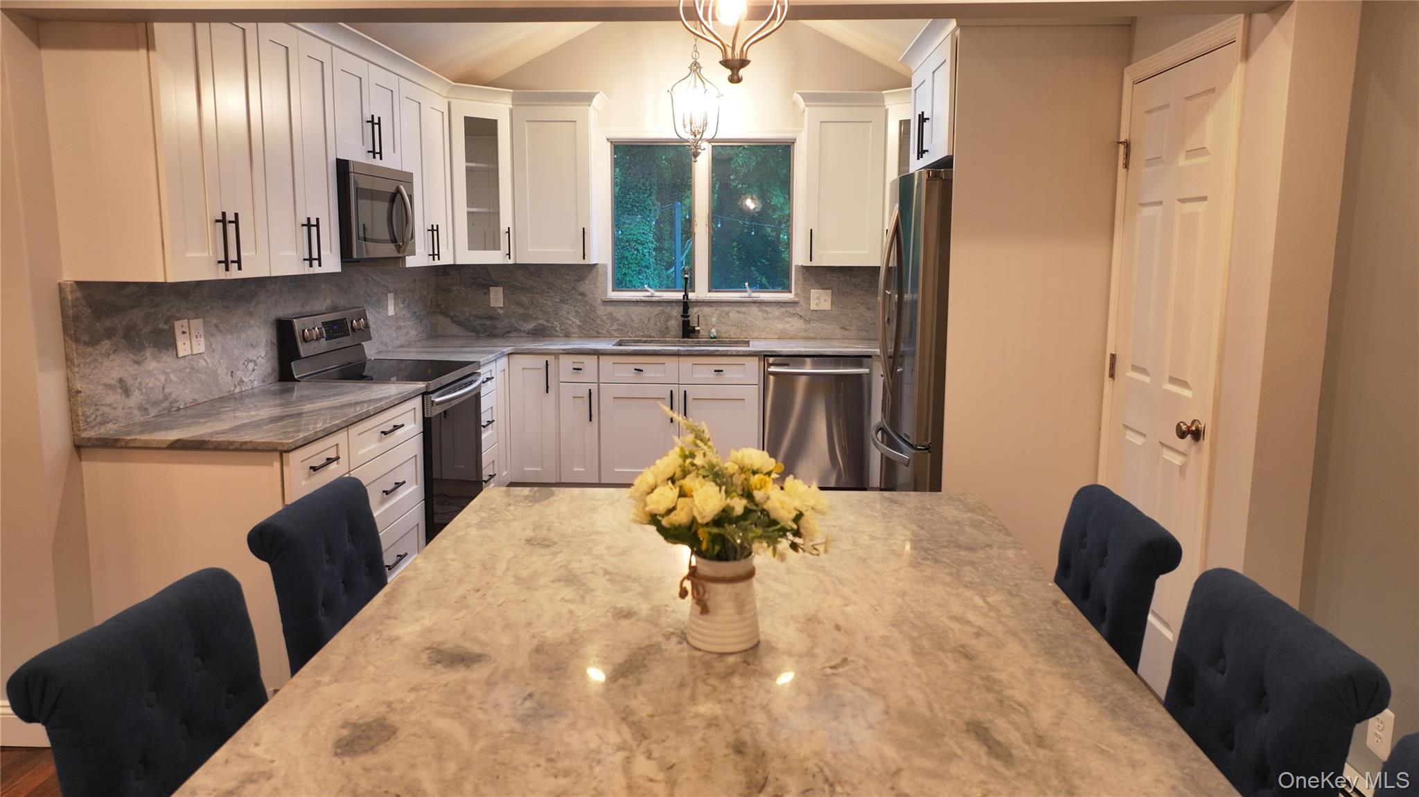 522 Moriches Road St. James, NY 11780 - Photo 13 of 49 a kitchen with stainless steel appliances granite countertop a sink a stove and a wooden floors