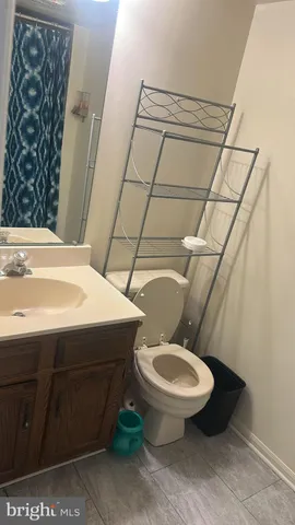 a view of kitchen with sink and refrigerator