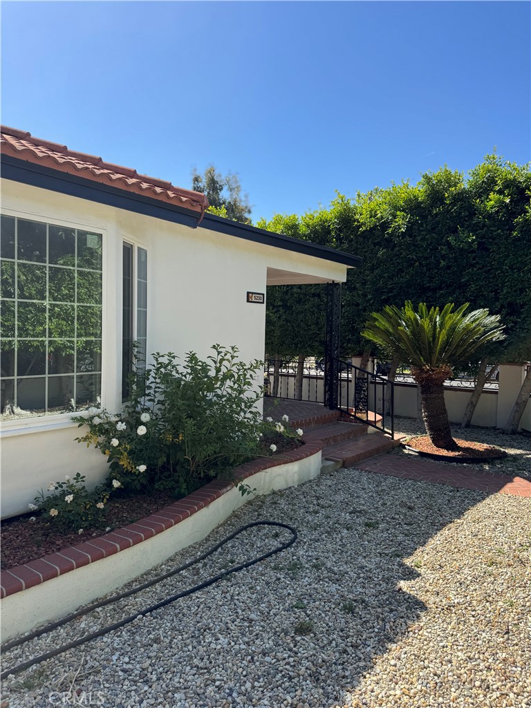 5230 Seville Avenue Encino, CA 91316 - Photo 15 of 61 a front view of a house with garden