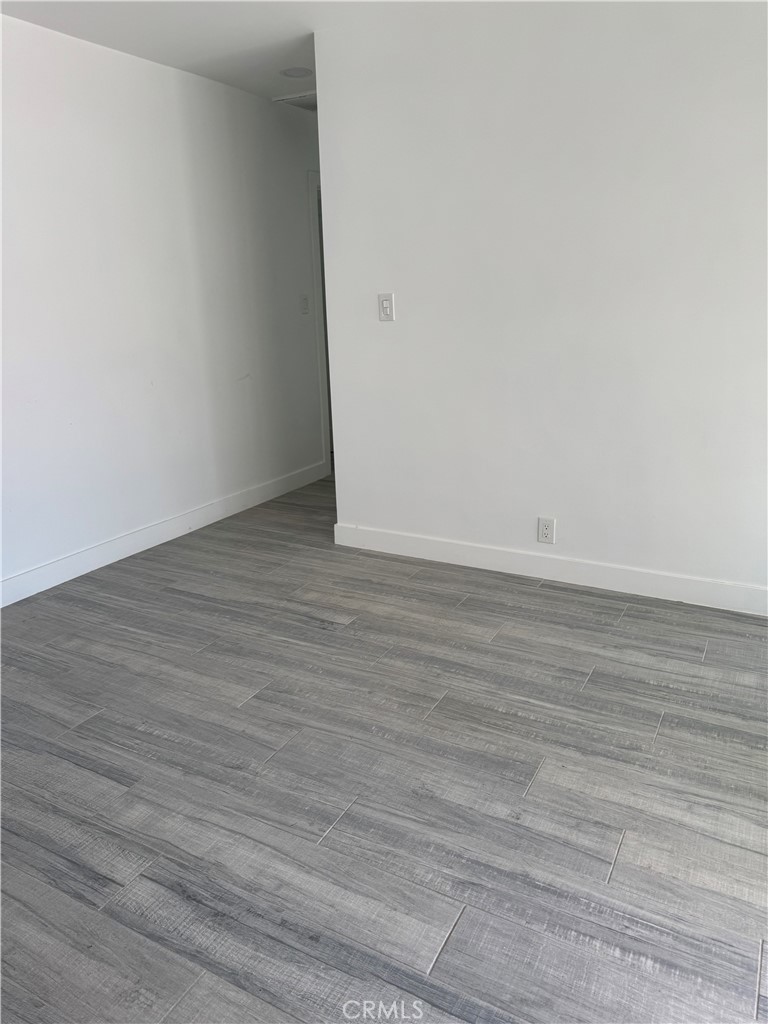 5230 Seville Avenue Encino, CA 91316 - Photo 19 of 61 a view of an empty room with wooden floor