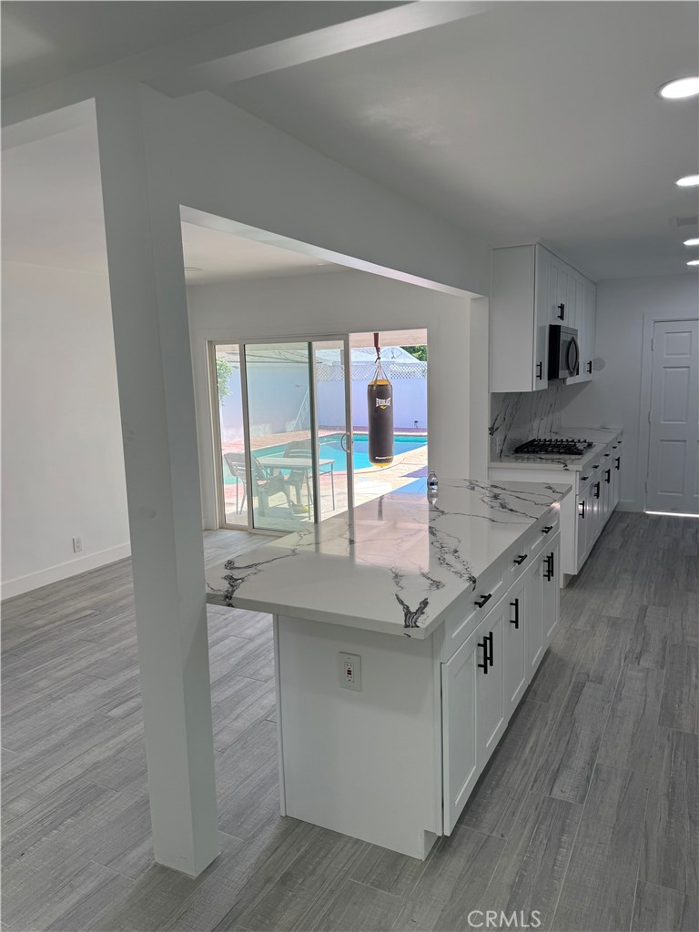 5230 Seville Avenue Encino, CA 91316 - Photo 20 of 61 a kitchen with stainless steel appliances granite countertop a stove and a sink
