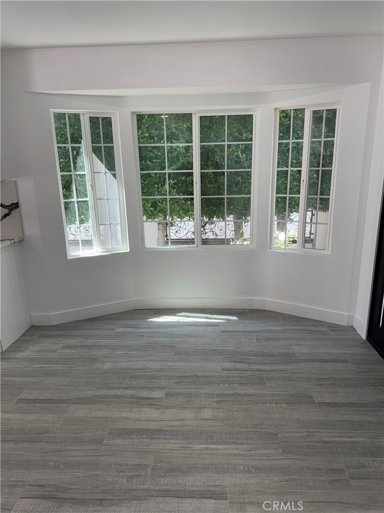 5230 Seville Avenue Encino, CA 91316 - Photo 22 of 61 a view of empty room with wooden floor and fan