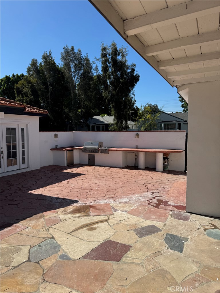 5230 Seville Avenue Encino, CA 91316 - Photo 24 of 61 a backyard of a house with table and chairs
