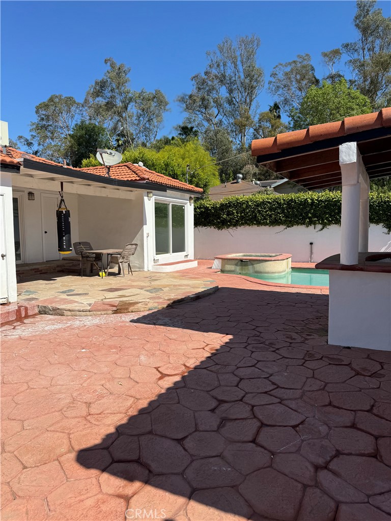 5230 Seville Avenue Encino, CA 91316 - Photo 27 of 61 a view of a house with pool and sitting area