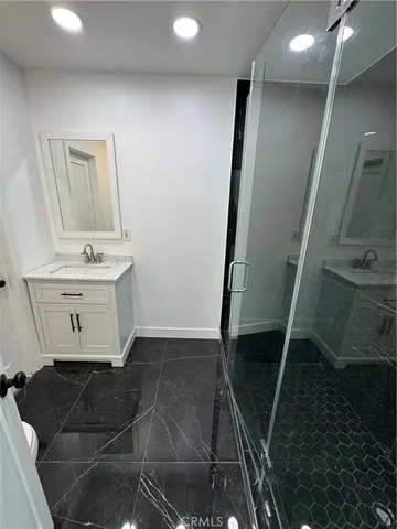 a bathroom with a shower and a sink