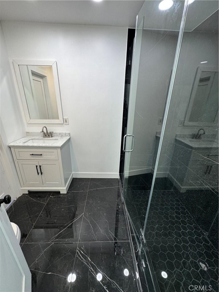 5230 Seville Avenue Encino, CA 91316 - Photo 35 of 61 a bathroom with a sink and a mirror