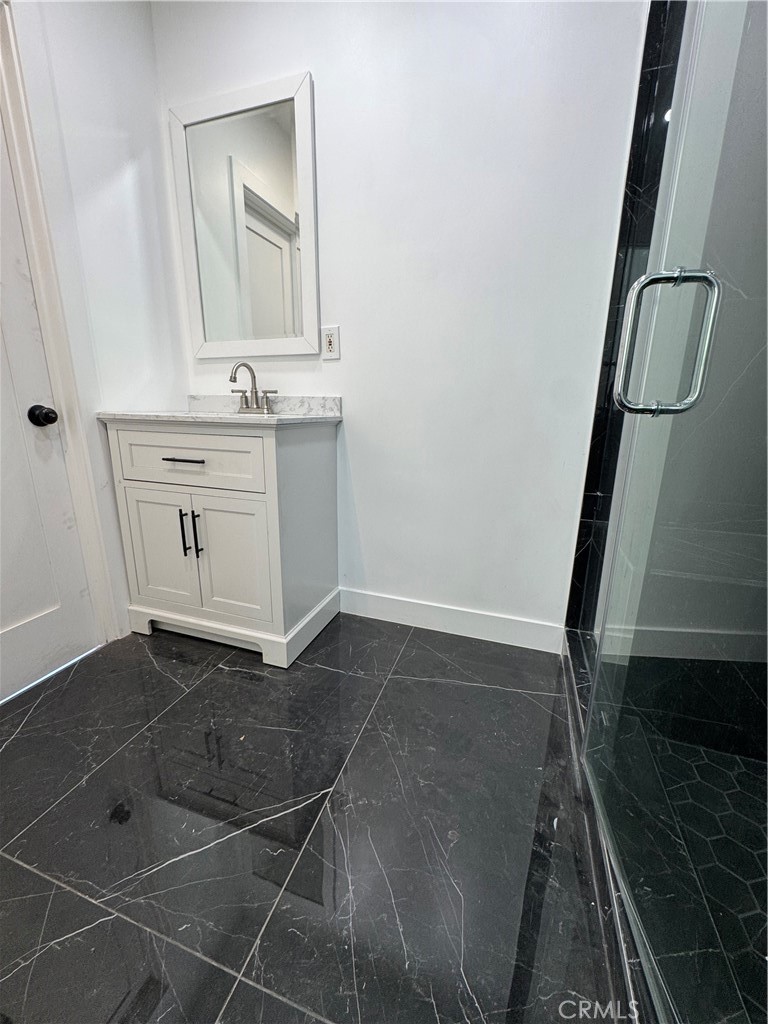 5230 Seville Avenue Encino, CA 91316 - Photo 36 of 61 a bathroom with a sink a toilet and mirror