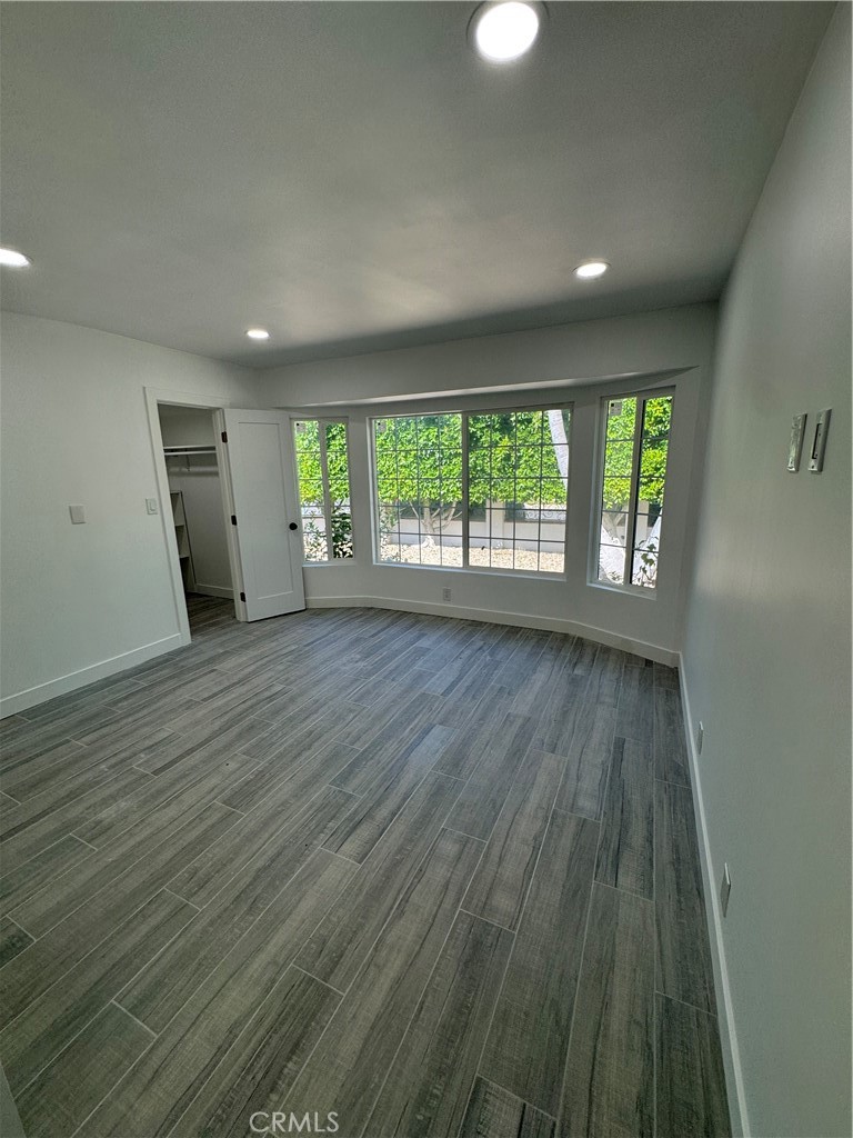 5230 Seville Avenue Encino, CA 91316 - Photo 45 of 61 an empty room with wooden floor and windows