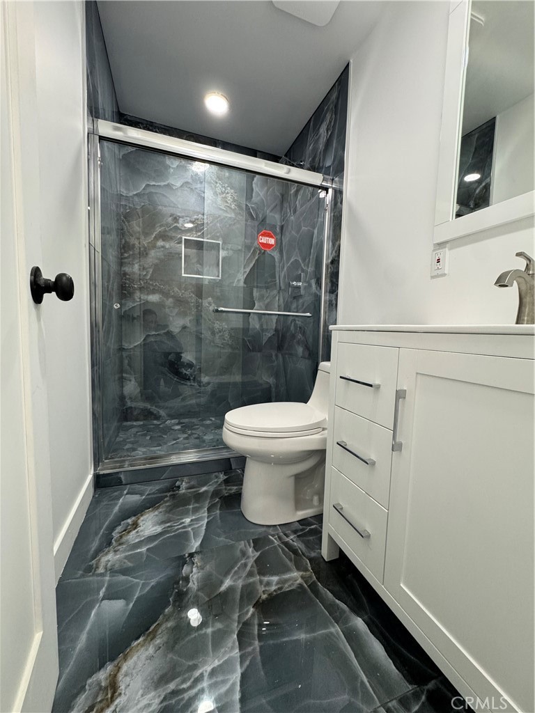 5230 Seville Avenue Encino, CA 91316 - Photo 48 of 61 a bathroom with a toilet and a shower