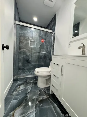 a kitchen with stainless steel appliances a stove a sink and a refrigerator