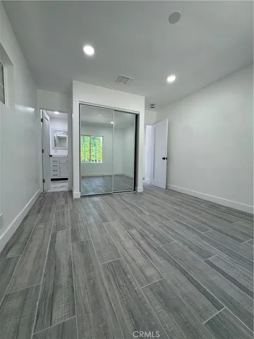 a large white kitchen with stainless steel appliances granite countertop a stove and a sink