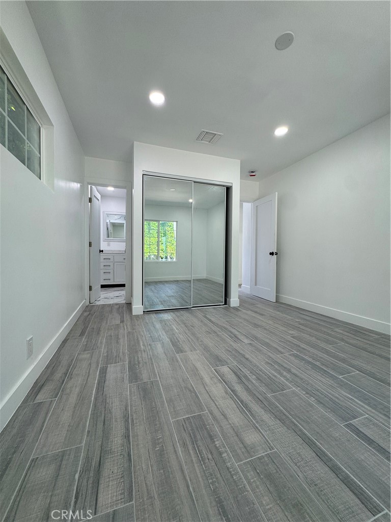 5230 Seville Avenue Encino, CA 91316 - Photo 51 of 61 an empty room with wooden floor and windows