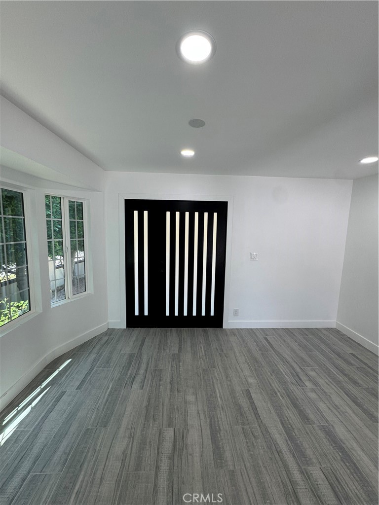 5230 Seville Avenue Encino, CA 91316 - Photo 58 of 61 an empty room with wooden floor and windows