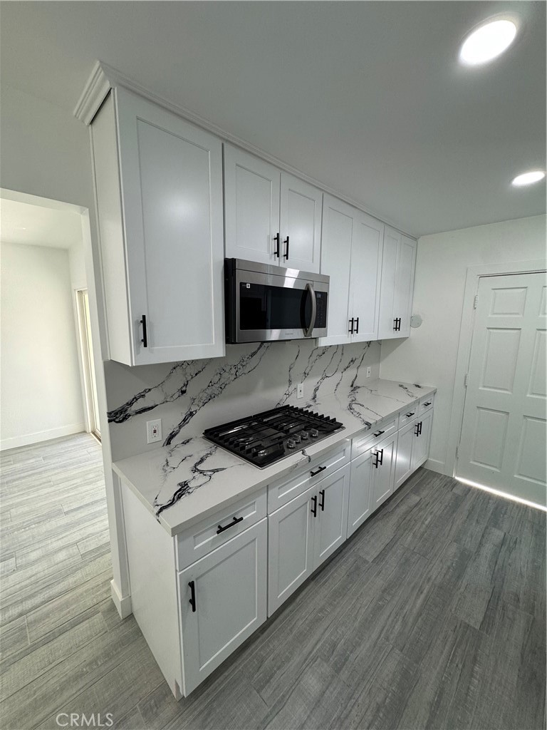 5230 Seville Avenue Encino, CA 91316 - Photo 60 of 61 a kitchen with stainless steel appliances a stove a sink and a refrigerator