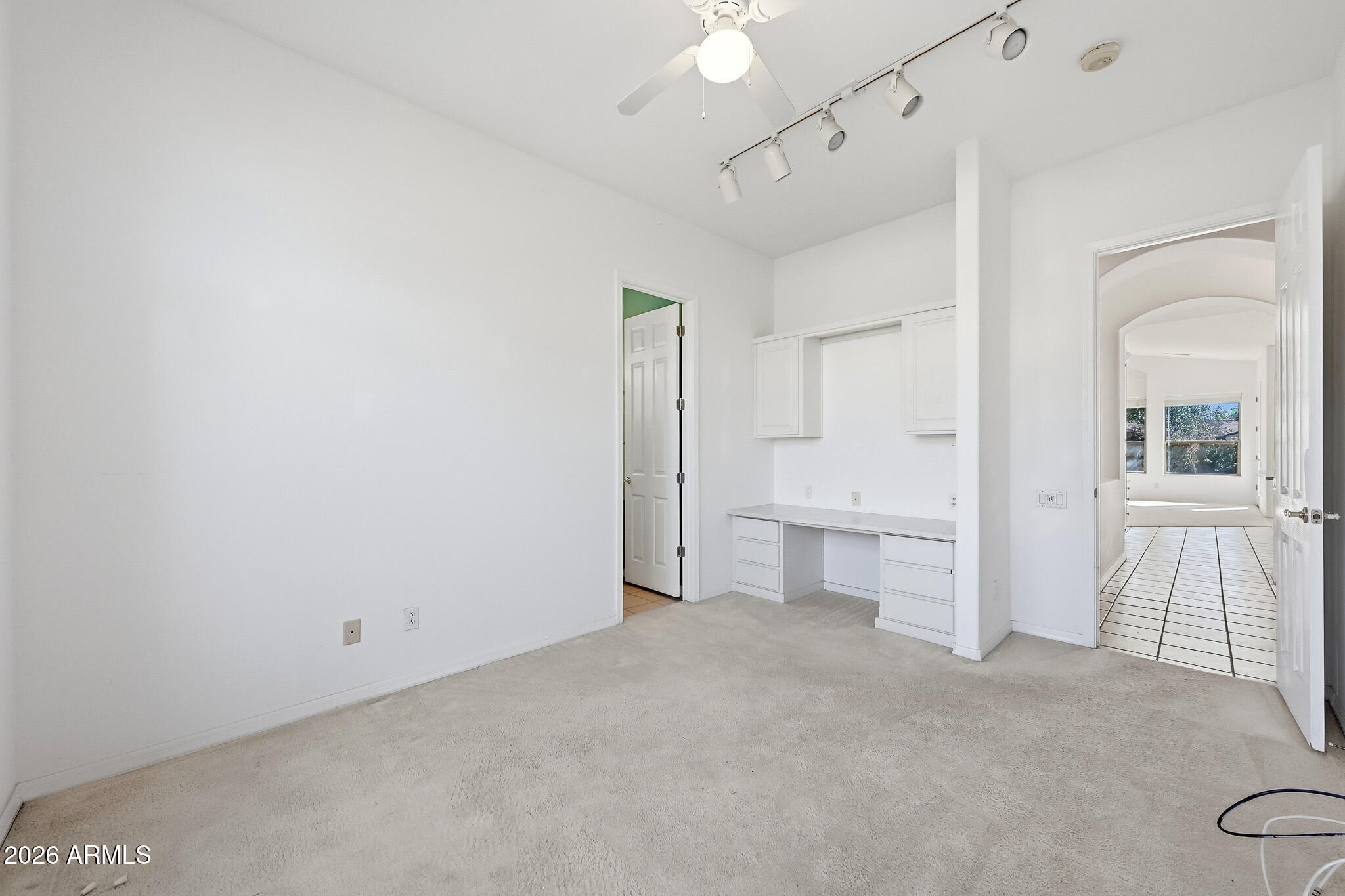 4149 North 49th Way Phoenix, AZ 85018 - Photo 13 of 25 a view of an empty room with window and cabinet