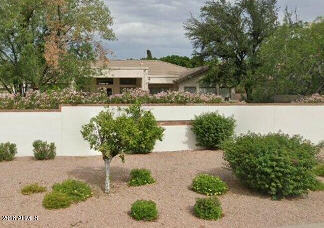 4149 North 49th Way Phoenix, AZ 85018 - Photo 17 of 25 a front view of a house with a yard and potted plants