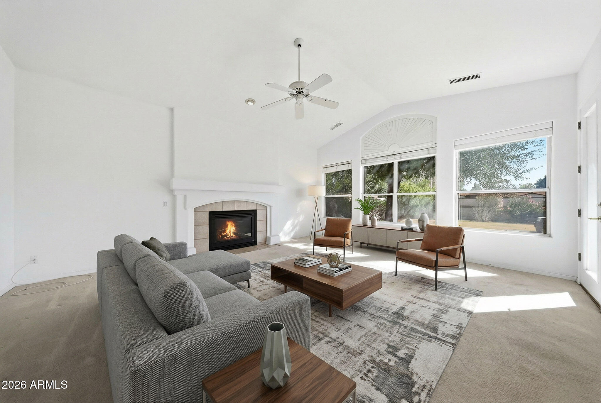 4149 North 49th Way Phoenix, AZ 85018 - Photo 2 of 25 a living room with furniture a fireplace and a floor to ceiling window
