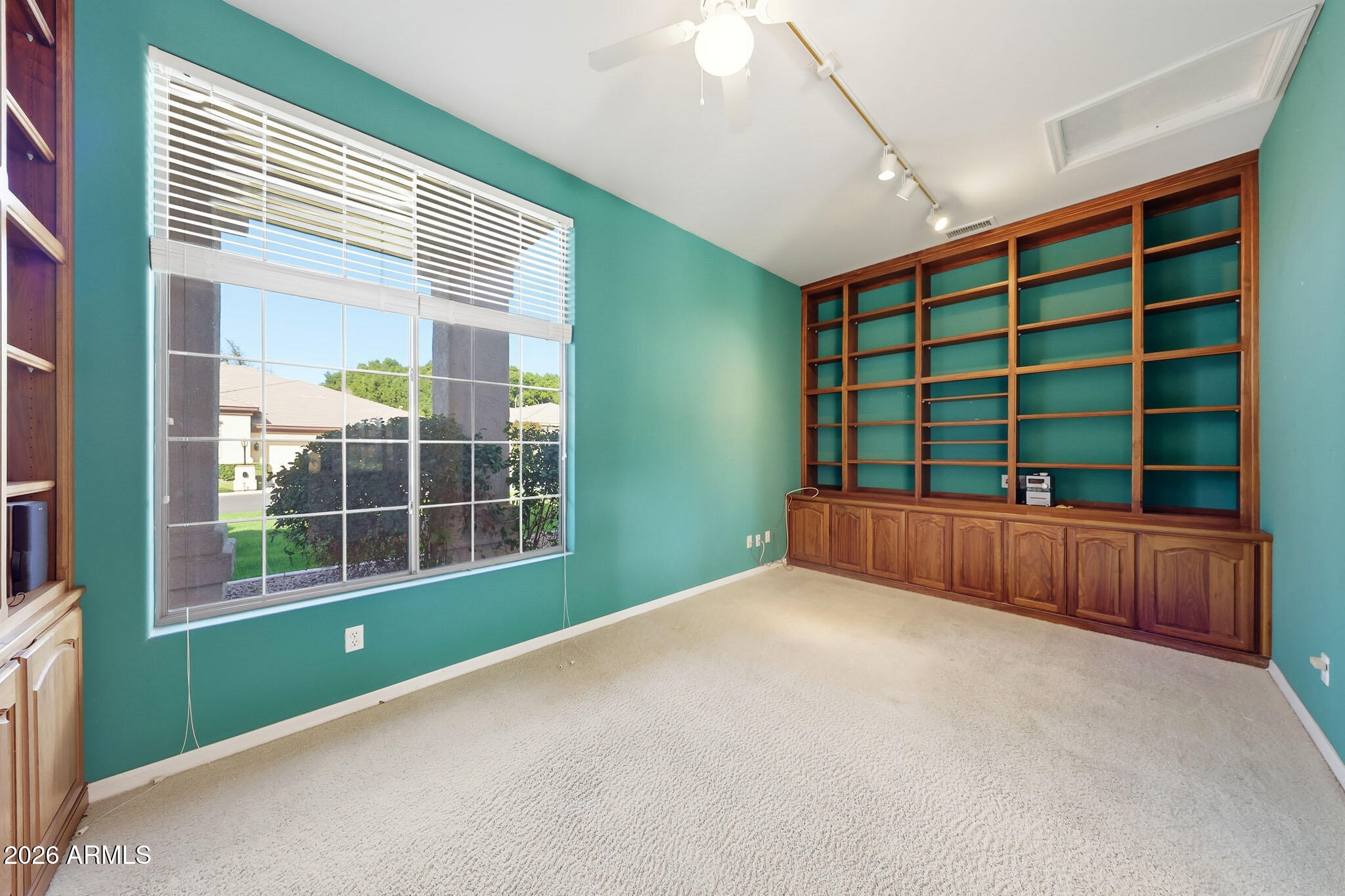 4149 North 49th Way Phoenix, AZ 85018 - Photo 8 of 25 a view of an empty room with a window and brick walls