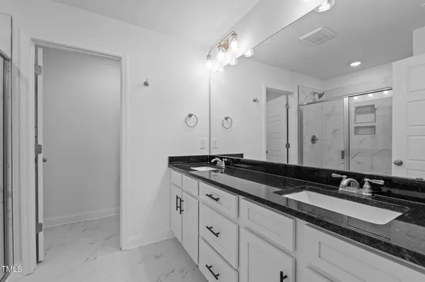 a bathroom with a glass door shower