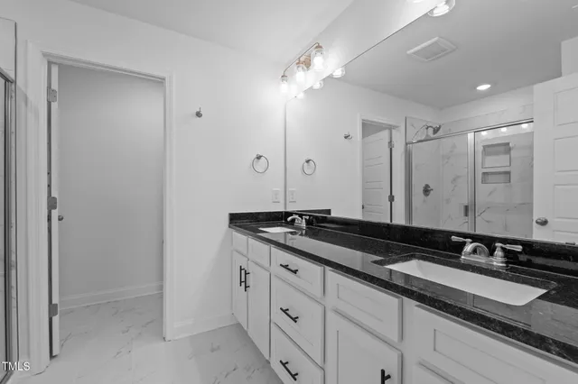 a bathroom with a glass door shower