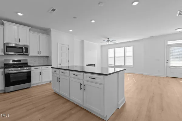 a view of kitchen with granite countertop cabinets and a oven