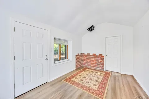 a view of a room with wooden floor and windows