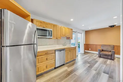 a kitchen with stainless steel appliances a refrigerator and a stove top oven