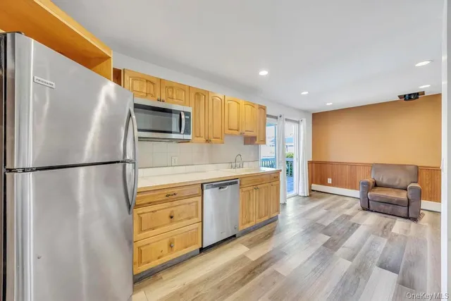 a kitchen with stainless steel appliances a refrigerator and a stove top oven