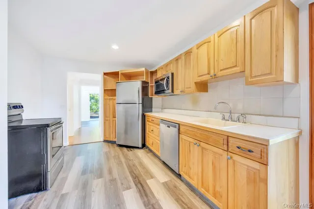 a kitchen with stainless steel appliances a refrigerator sink and cabinets