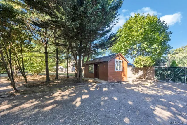 a view of wooden house and a yard