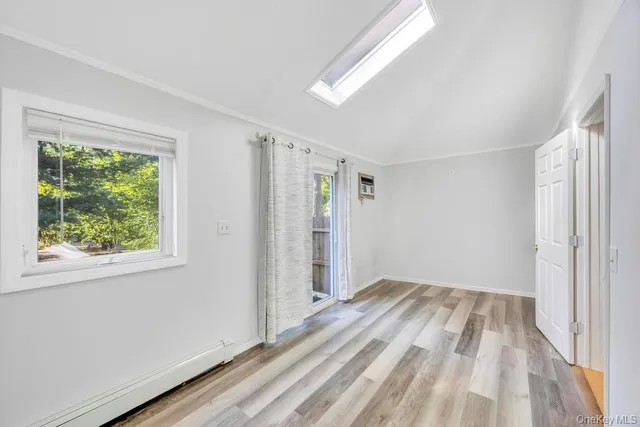 a view of room with window and hardwood floor