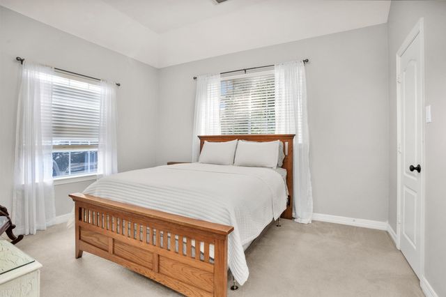 a bathroom with a sink a toilet and shower curtain