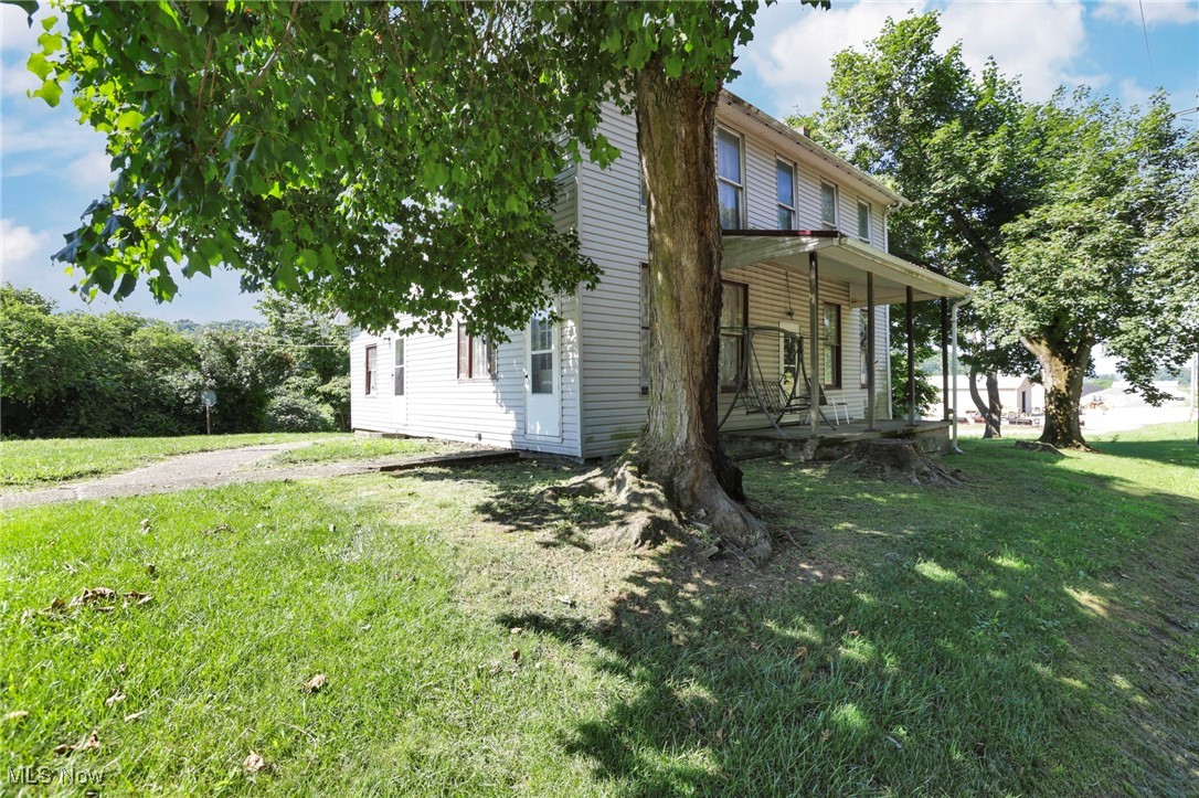 21372 Bridgewater Road Quaker City, OH 43773 - Photo 4 of 39 View of home's exterior featuring a yard and a porch