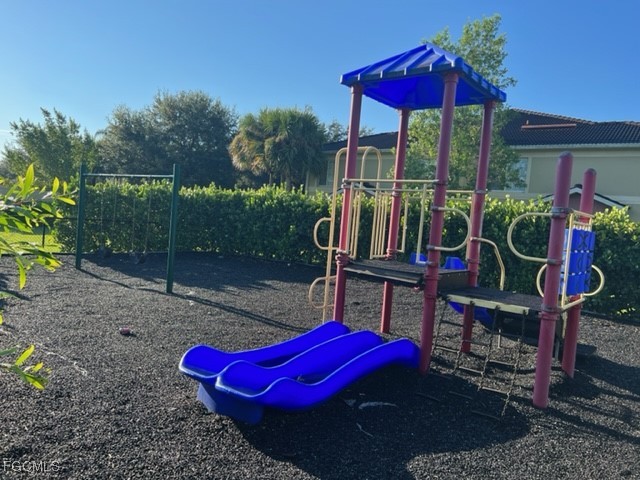 9440 Ivy Brook Run, Unit 509 Fort Myers, FL 33913 - Photo 17 of 17 a view of a deck with table and chairs under an umbrella