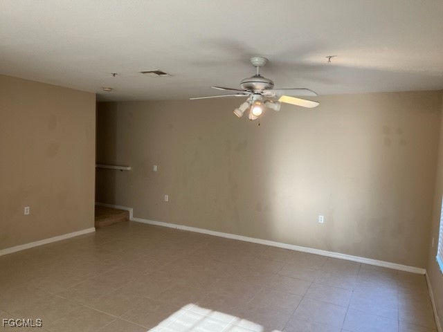9440 Ivy Brook Run, Unit 509 Fort Myers, FL 33913 - Photo 2 of 17 an empty room with a ceiling fan and a window