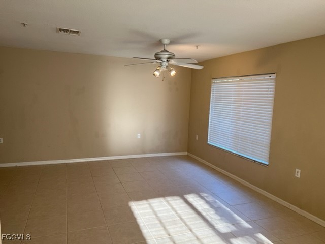 9440 Ivy Brook Run, Unit 509 Fort Myers, FL 33913 - Photo 3 of 17 an empty room with windows and fan