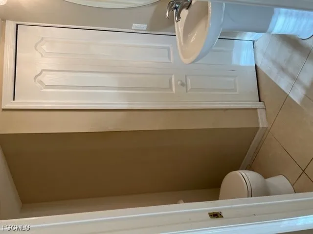 a view of staircase with white walls and railing