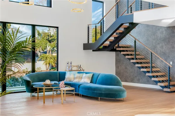 a living room with furniture and stairs