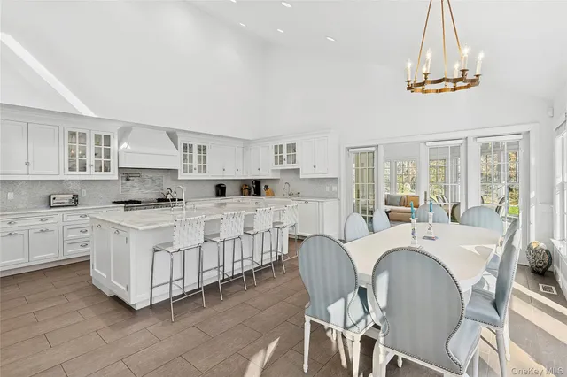 a large white kitchen with cabinets