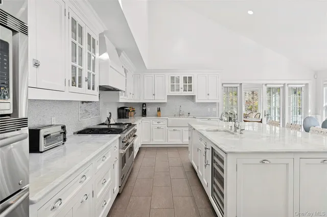 a kitchen with stainless steel appliances granite countertop a sink and cabinets